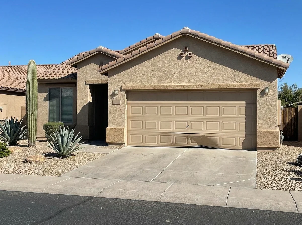 Closed white garage door on a suburban home